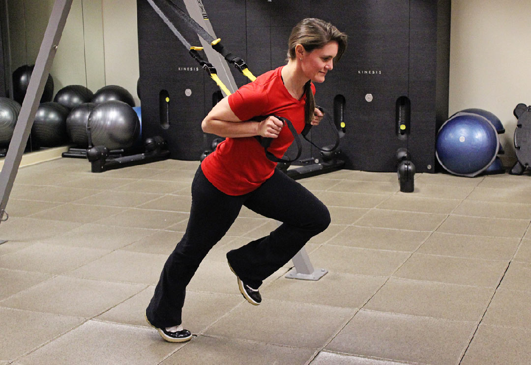 Female trainer doing a TRX exercise