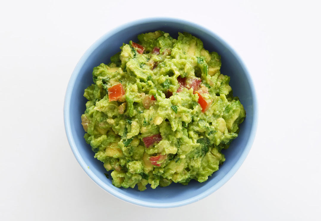 Bowl of yummy guacamole made with kale