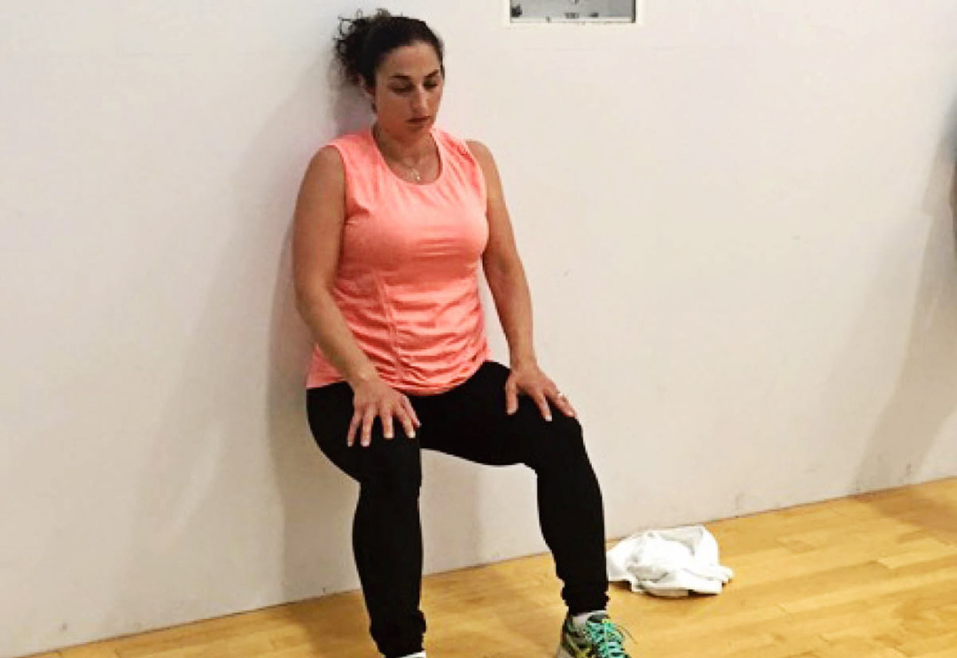 Rev32 participant Stephanie doing a wall sit