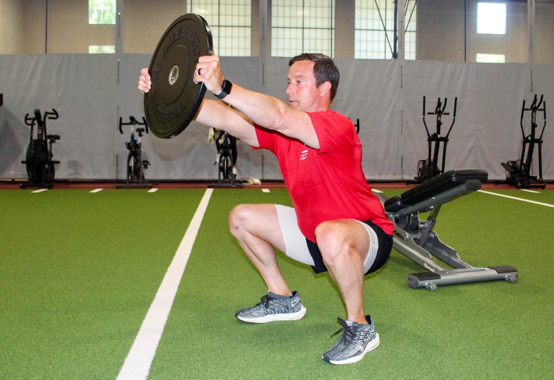 Elite Personal Trainer Michael Des Gaines doing a squat for the workout of the month