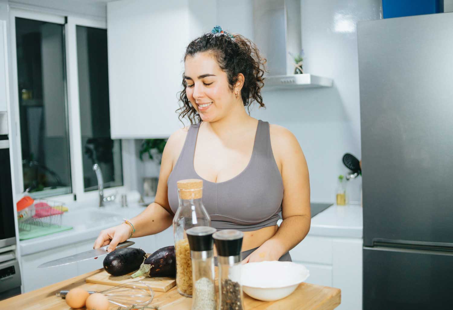 A woman cooking healthy food in her kitchen