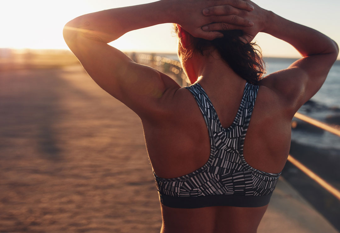 Woman showing off her muscular back from the Go Backless Workout of the Month