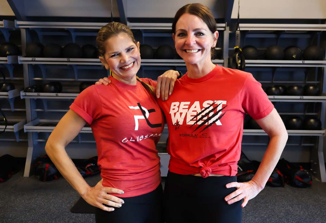 Personal trainers demonstrating partner workout at ClubSport